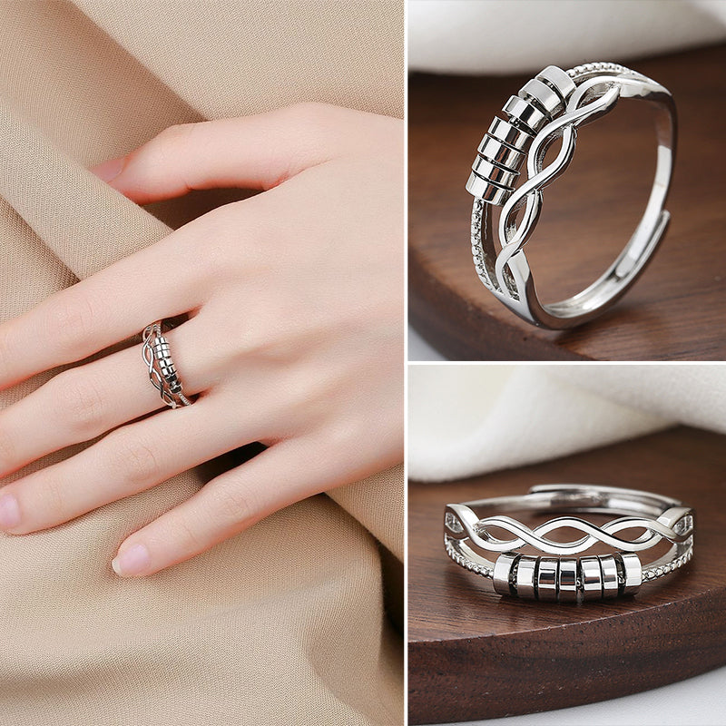 Unisex silver infinity fidget ring for anxiety relief, adjustable band, close-up on intricate design