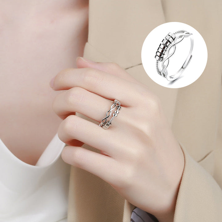 Unisex silver infinity fidget ring on a hand, highlighting its adjustable feature for anxiety relief