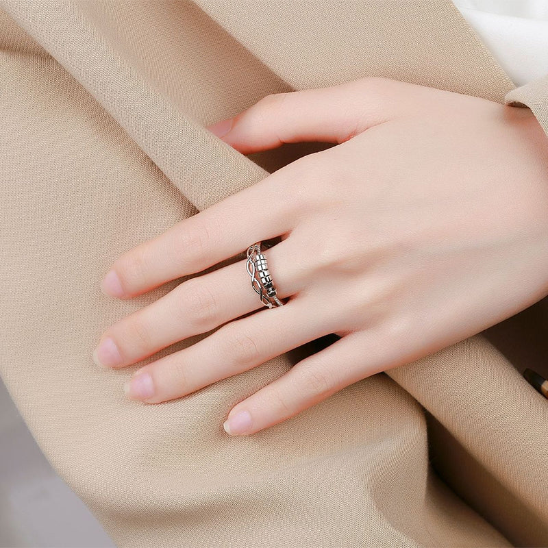 Close-up of an adjustable infinity symbol fidget ring in silver, designed for stress and anxiety