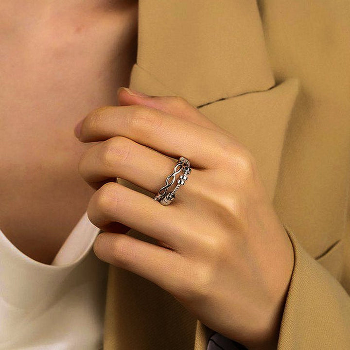 Unisex silver ring with infinity symbol, a stylish fidget accessory for anxiety relief, side view