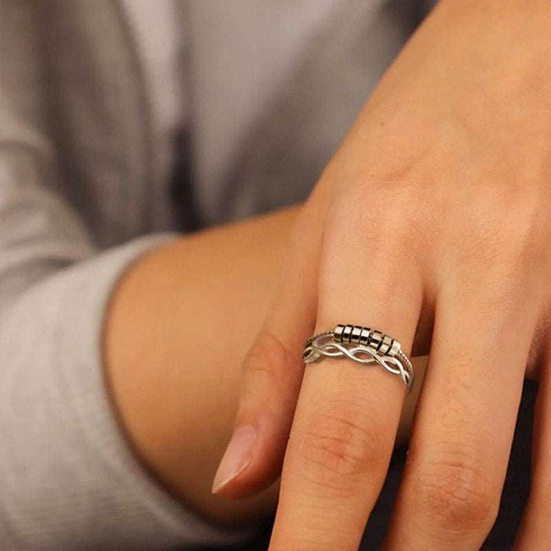 Adjustable silver infinity fidget ring, ideal for anxiety relief, displayed on a clean background