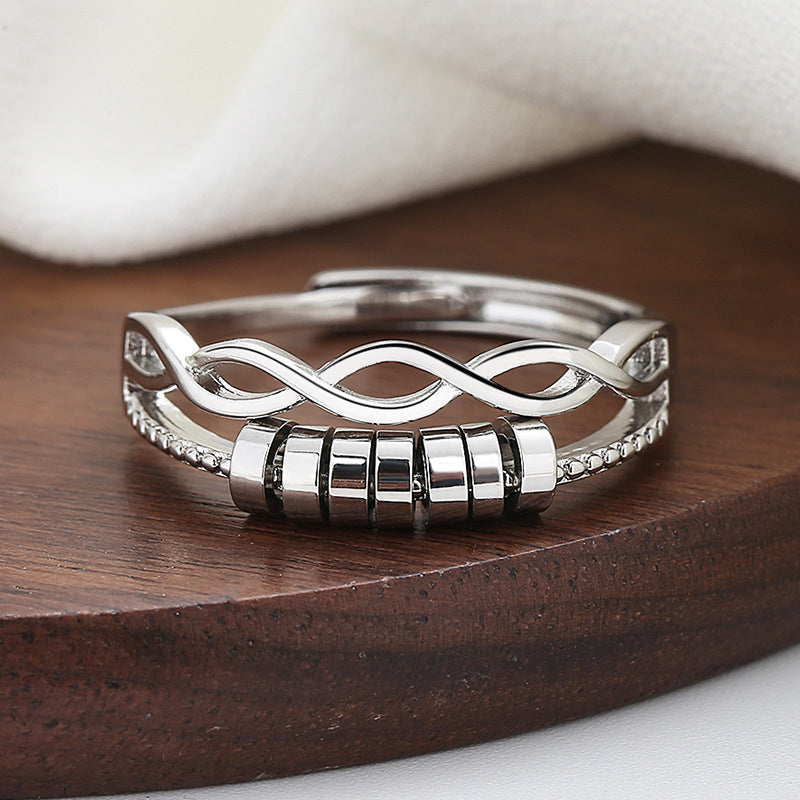 Detail view of the spinner mechanism on a silver adjustable infinity fidget ring for anxiety