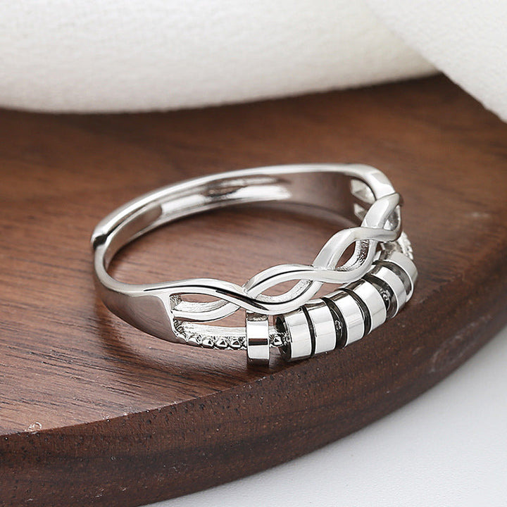 Stack of two silver adjustable infinity fidget rings, emphasizing unisex style and anxiety relief