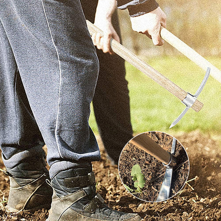 The full length of the pickaxe mattock resting on soil, demonstrating its practical size for various garden chores.