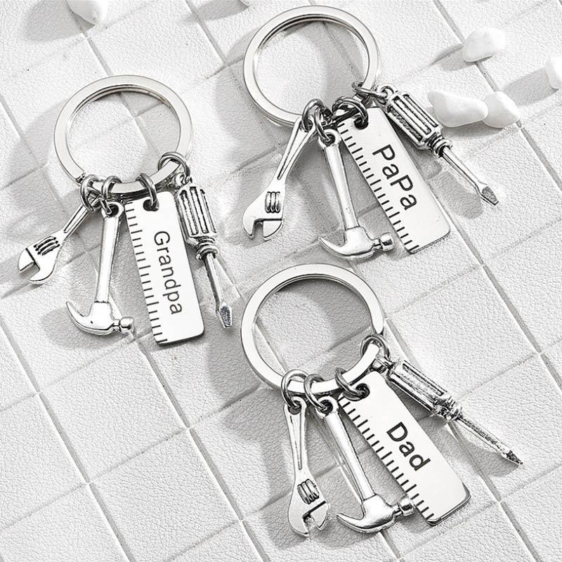 Close-up of a 'Best Dad Ever' engraved stainless steel keychain, a thoughtful men's accessory gift.