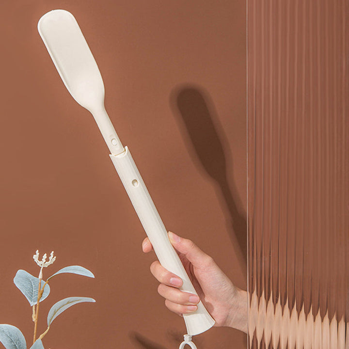 Silver telescopic long shoe horn against a neutral background, a simple yet effective footwear tool
