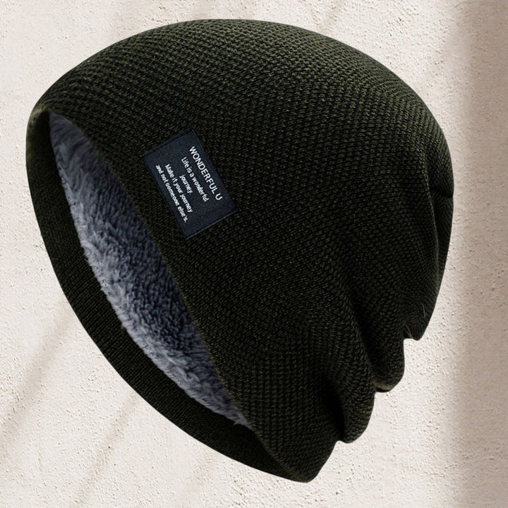 Person wearing a black unisex thermal knit beanie hat, demonstrating its comfortable fit and warmth.