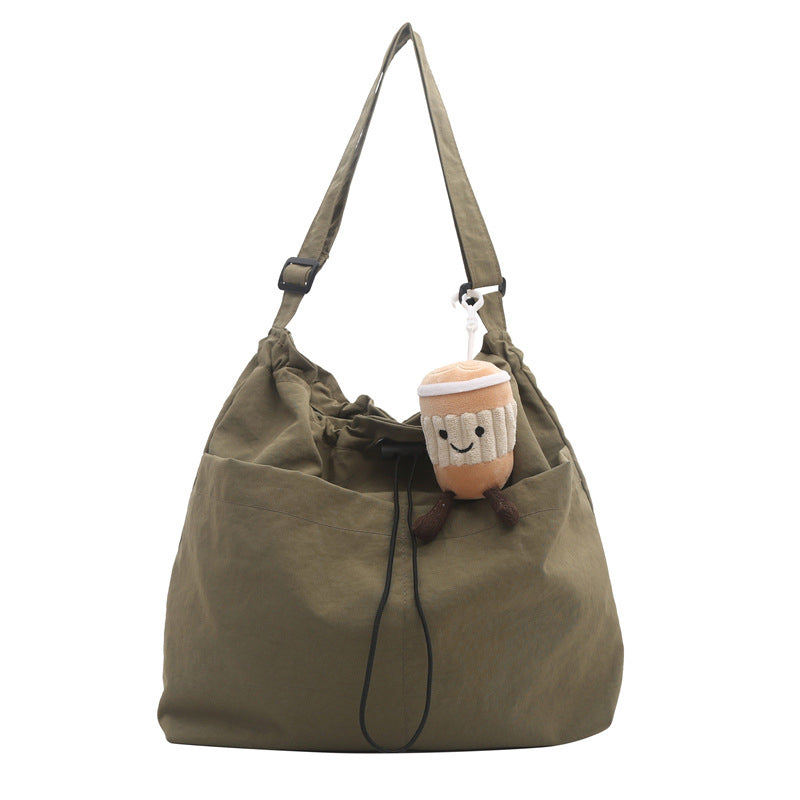 Black unisex bucket-style messenger bag, ultra-light nylon for casual, hands-free carrying