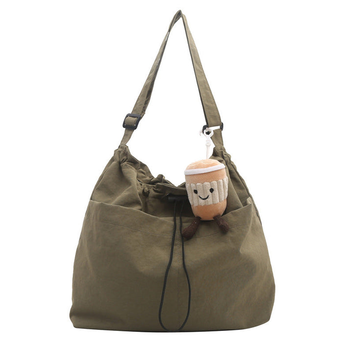 Black unisex bucket-style messenger bag, ultra-light nylon for casual, hands-free carrying