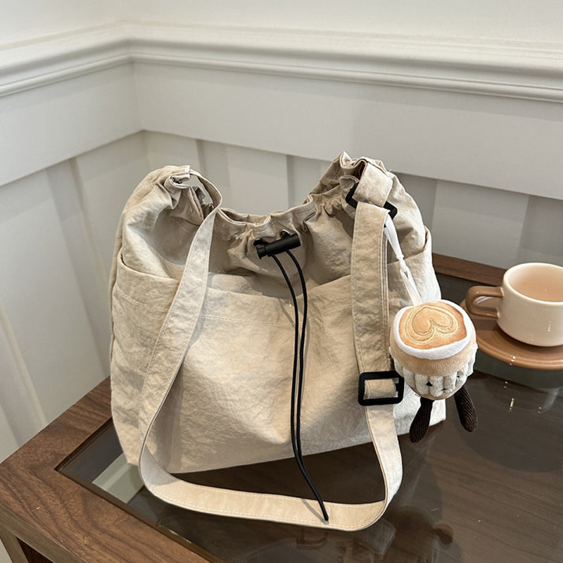 Detail of closure on a black ultra-light casual messenger bag, secure and easy-to-use design