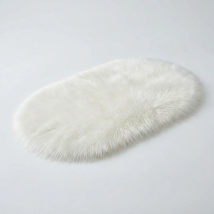 Luxurious soft faux fur oval plush rug for a cozy bedroom, adding modern comfort to your home.