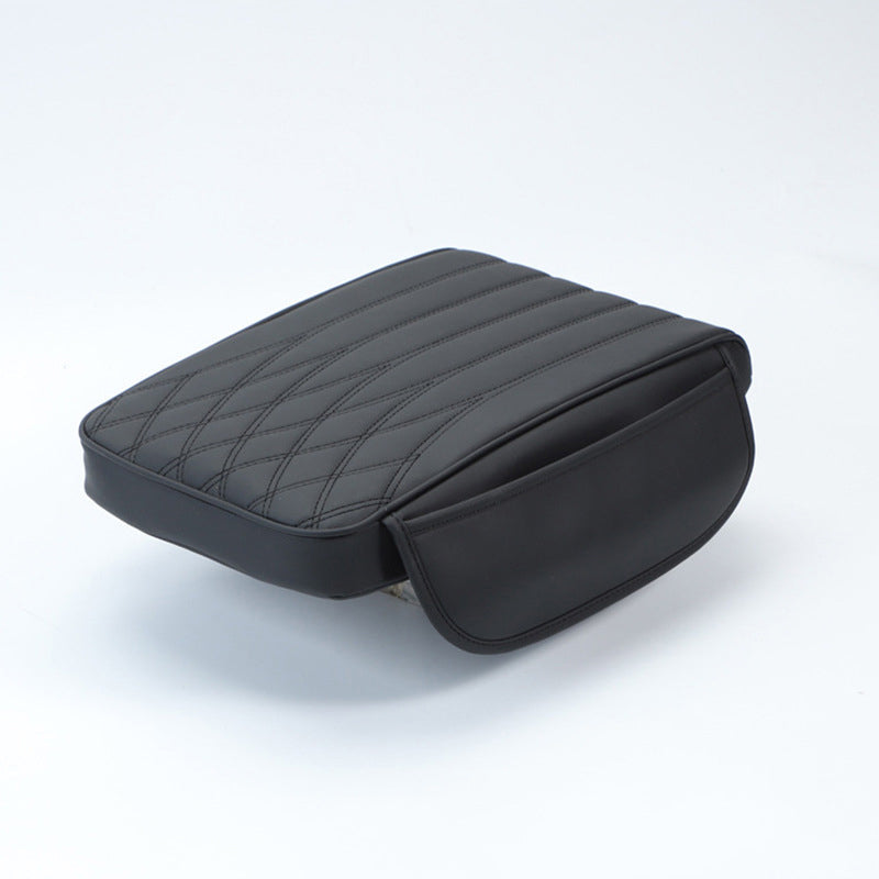 Side view of a thick leather car armrest pad, illustrating its ergonomic design and driving aid.