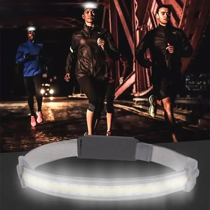 Hands-free LED headlamp illuminating a dark trail, emphasizing its function for outdoor exploration