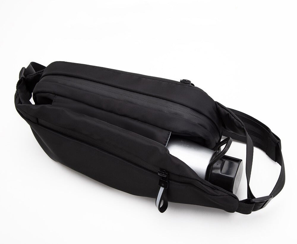 Close-up of a multi-pocket fanny pack showing secure zipper compartments. Ideal water-resistant waist bag for gear.