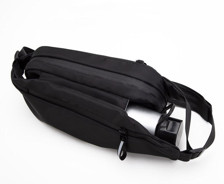 Close-up of a multi-pocket fanny pack showing secure zipper compartments. Ideal water-resistant waist bag for gear.