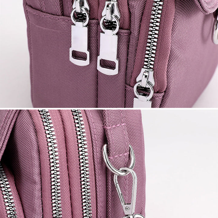 Black unisex waterproof daily bag, messenger style, featuring secure zippers & multiple pockets