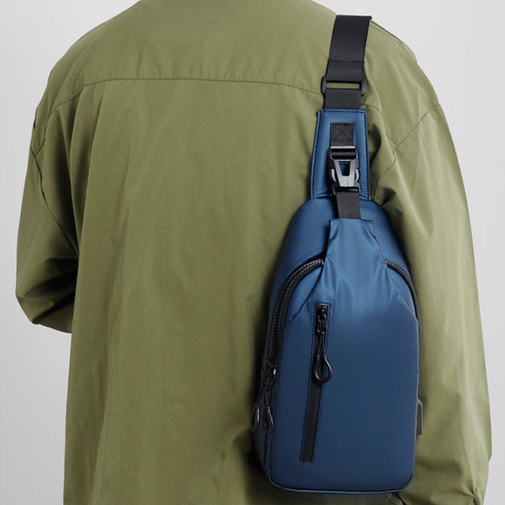 Waterproof chest bag laid flat, displaying all its features and pockets distinctly.