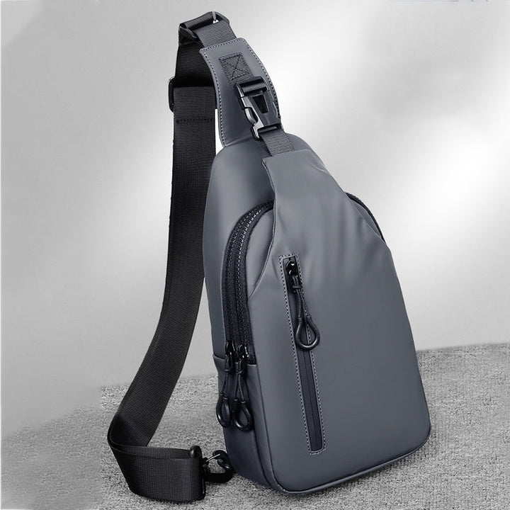 Close-up of USB charging port on a black waterproof travel sling bag, ready for device connection.