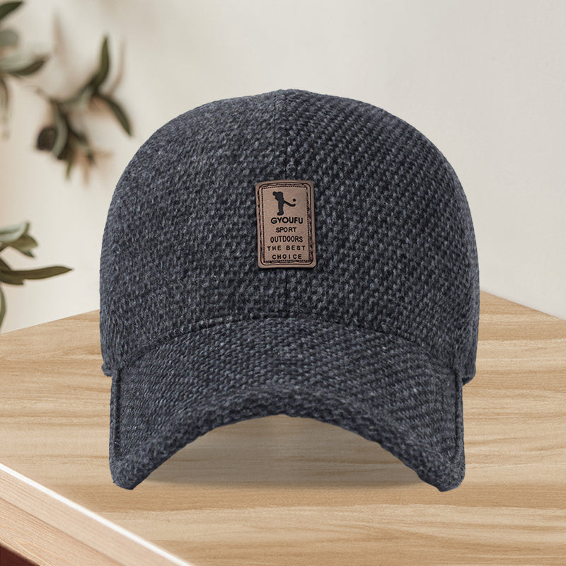 Close-up of wool blend fabric on unisex winter baseball cap, black, textured, showing quality material