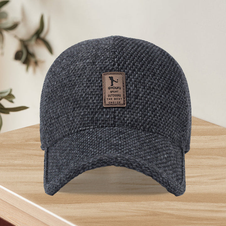 Close-up of wool blend fabric on unisex winter baseball cap, black, textured, showing quality material