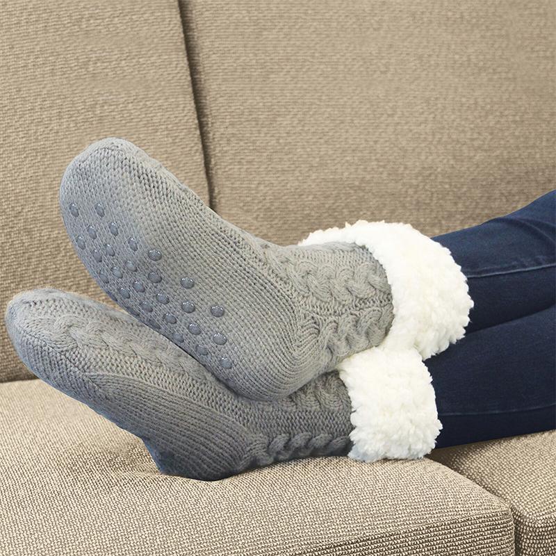 Comfortable unisex fleece-lined slipper socks, black, anti-slip dots, ideal for cold weather lounging.