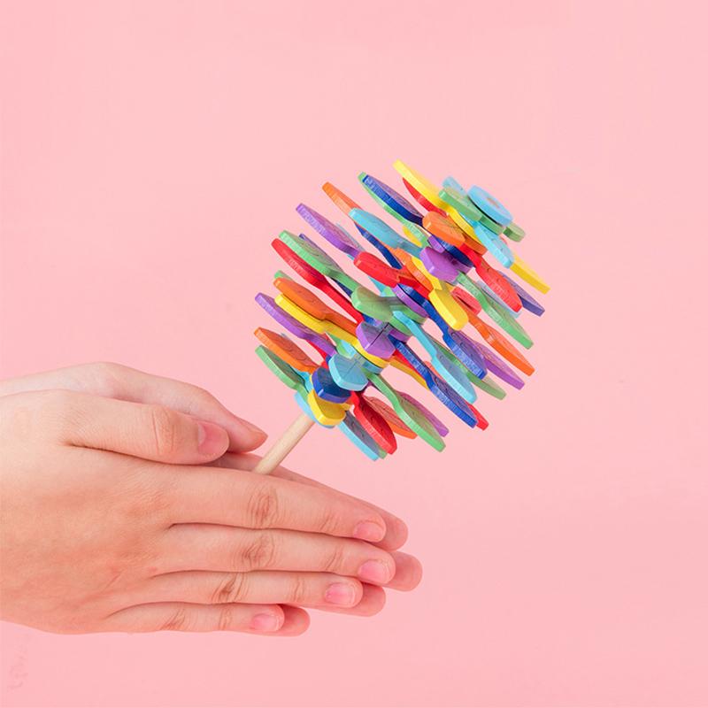 Close-up of a wooden Fibonacci lollipop fidget toy, showcasing its unique spiral design