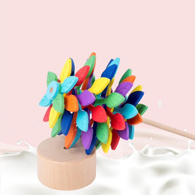 Child's hand playing with a natural wood Fibonacci lollipop fidget toy, educational benefit
