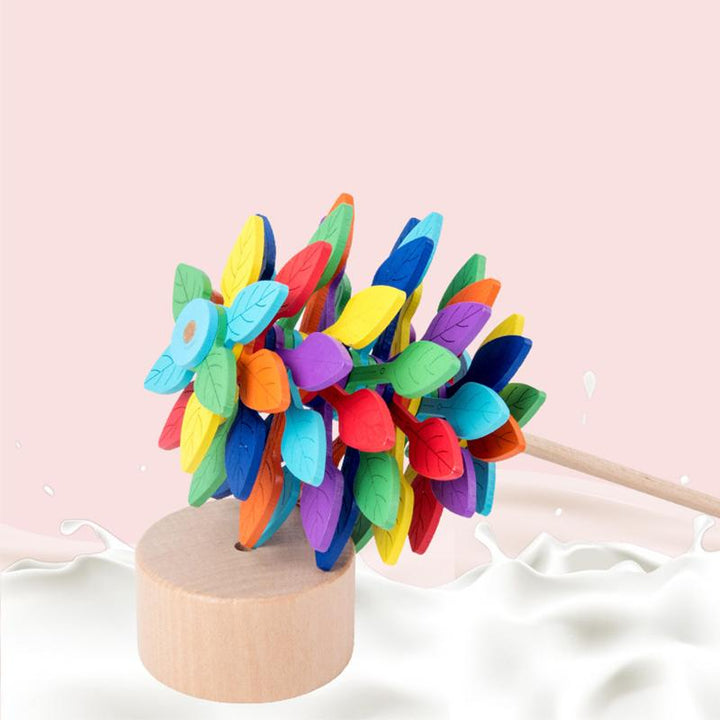 Child's hand playing with a natural wood Fibonacci lollipop fidget toy, educational benefit