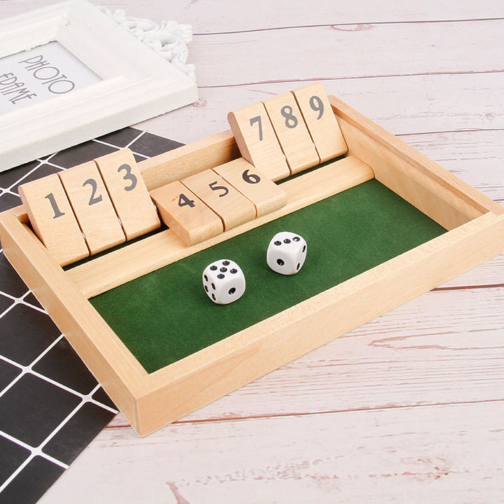 Close-up of a wooden table math game showing numbers and dice, a fun educational toy