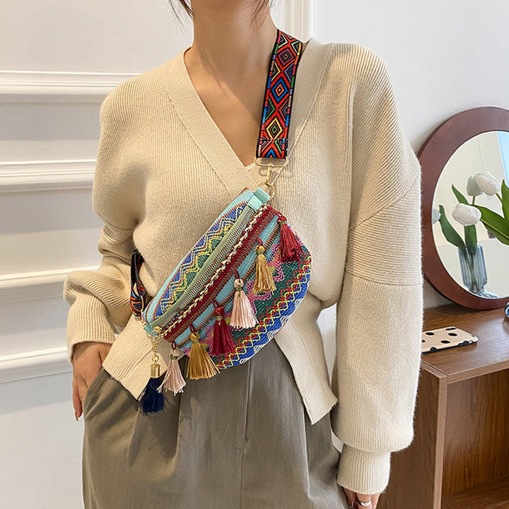 Close-up of a woven bohemian waist bag, showcasing its unique colorful texture.