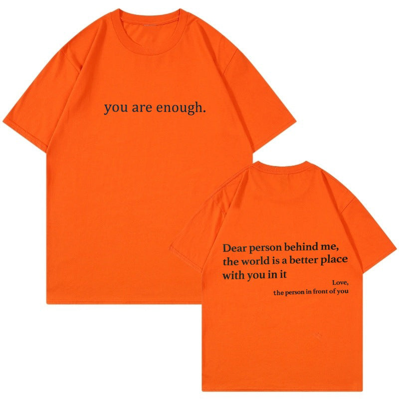 Stack of folded 'You Are Enough' inspirational cotton t-shirts, ready for gifting.
