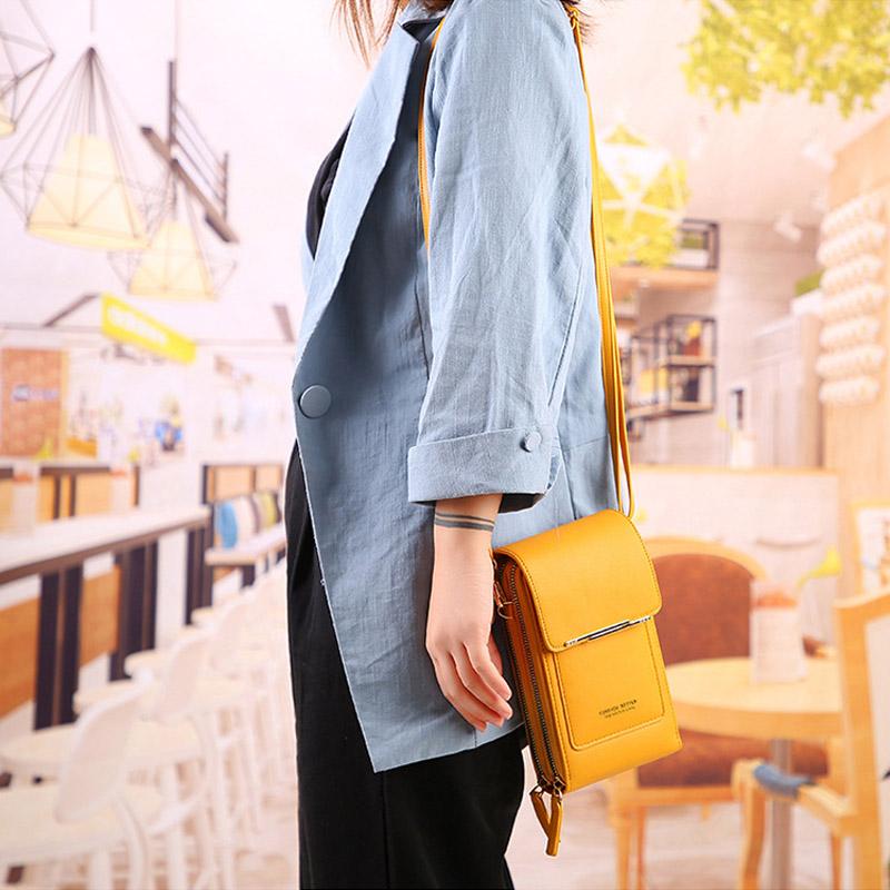 Front view of a universal crossbody phone case, dark blue PU leather, with magnetic snap closure. Fashionable phone holder.