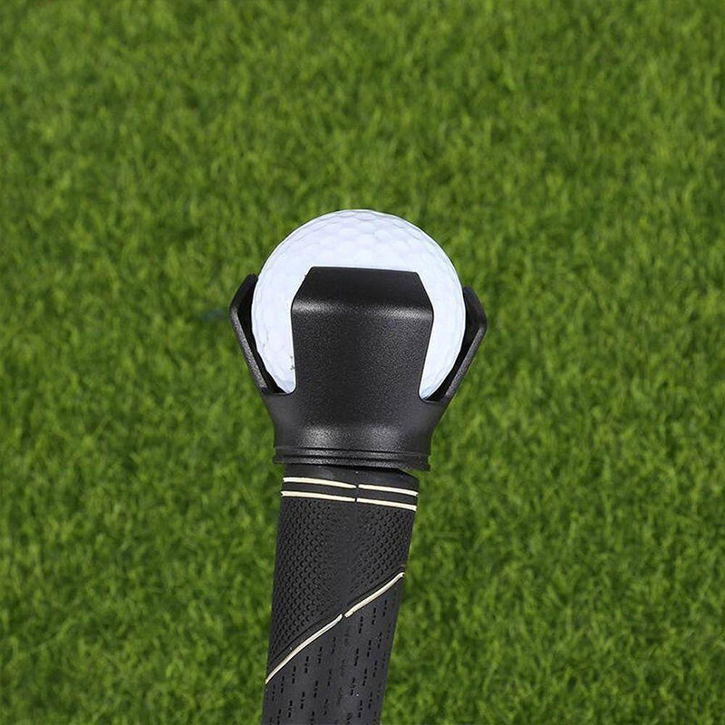 Black golf ball picker securely fitted onto a putter grip, ready for use during a golf game.