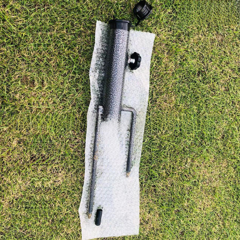 Close-up of the spiral auger tip of the ground anchor umbrella holder for stability.