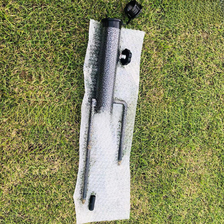 Close-up of the spiral auger tip of the ground anchor umbrella holder for stability.