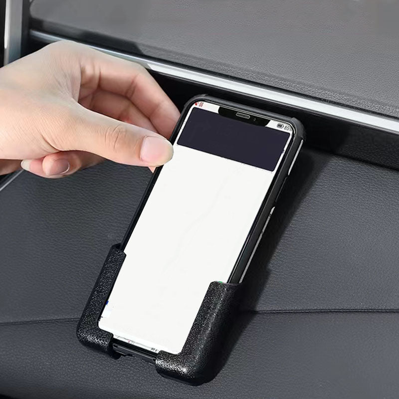 Universal sticky phone holder mounted on a dashboard, securely holding a smartphone for navigation