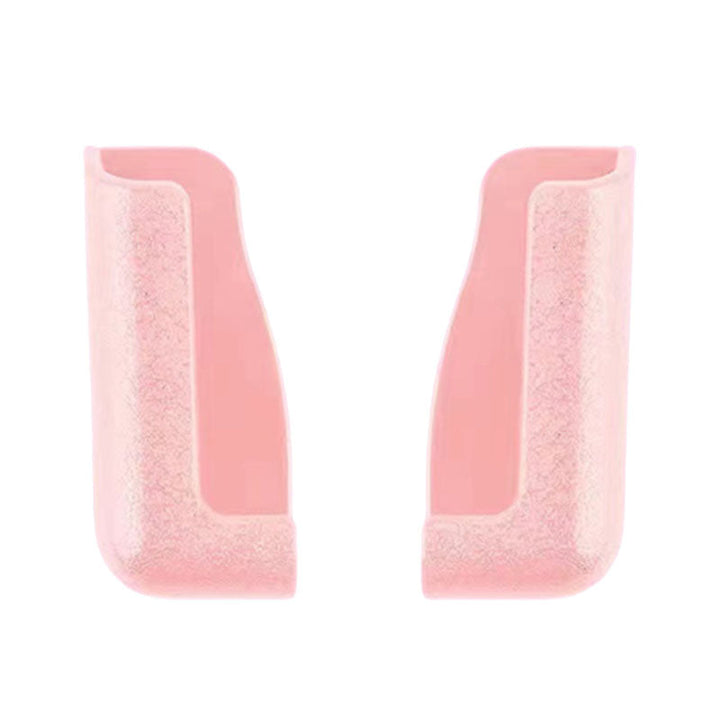 Set of two universal sticky phone holders, one black and one white, for various devices