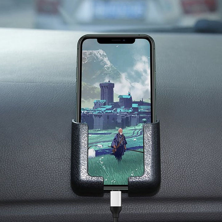 Car accessory: a sticky phone holder mounted on a vent, keeping a smartphone accessible
