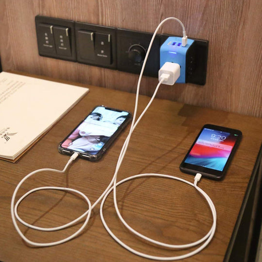Universal power adapter, compact design with 4 USB ports for hassle-free international travel.