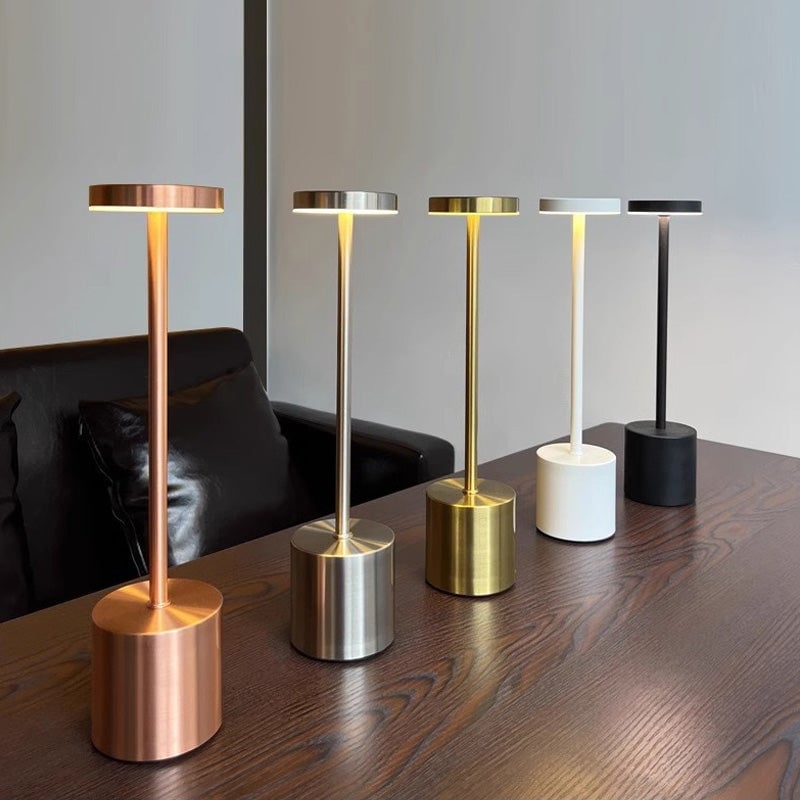 Rechargeable LED table lamp on a patio, demonstrating its portability and outdoor lighting use