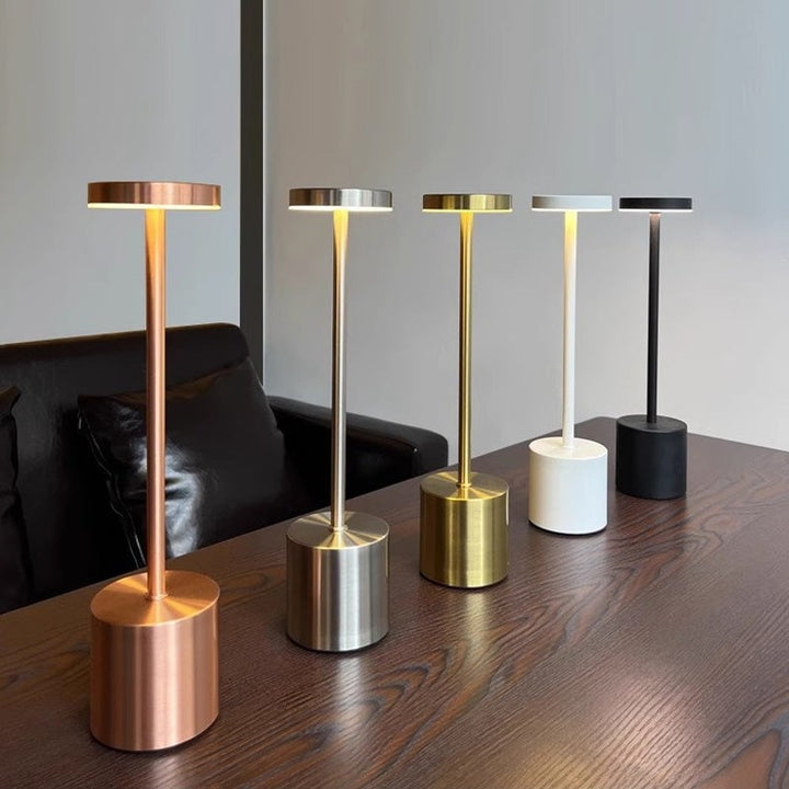 Rechargeable LED table lamp on a patio, demonstrating its portability and outdoor lighting use