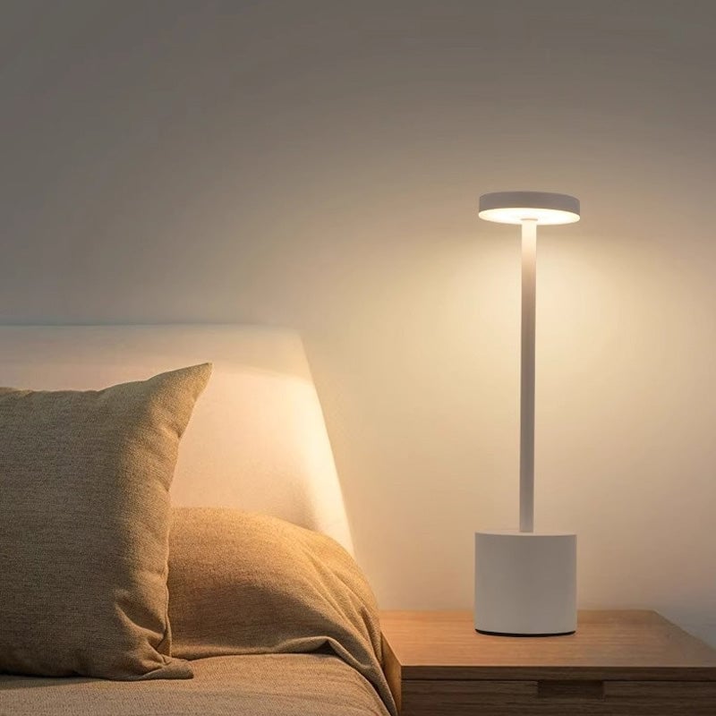 USB charging cable connected to a touch dimmable LED table lamp, ready for recharge