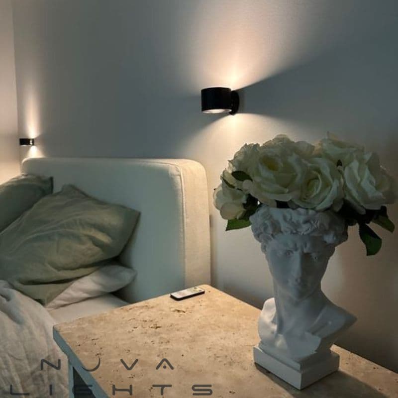 Modern LED Wall Sconce, USB rechargeable, shown illuminating a desk area for reading