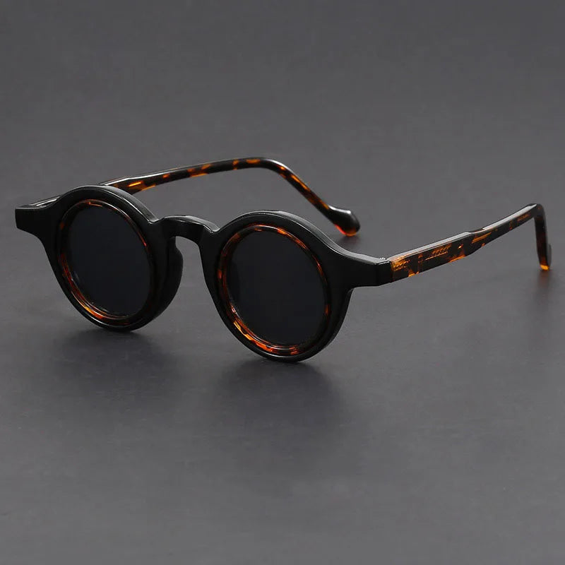 Close-up of Velari round frame sunglasses, showcasing the matte finish and unisex design.