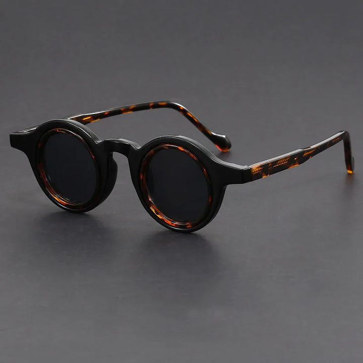 Close-up of Velari round frame sunglasses, showcasing the matte finish and unisex design.