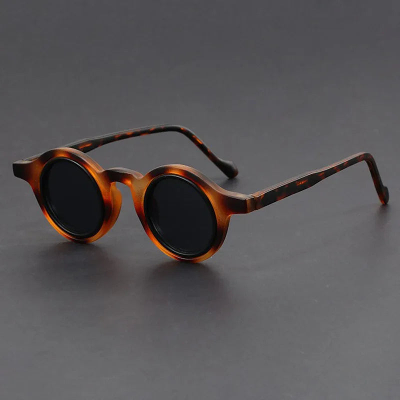 Unisex Velari round frame sunglasses on a white background, highlighting their sleek, modern aesthetic.