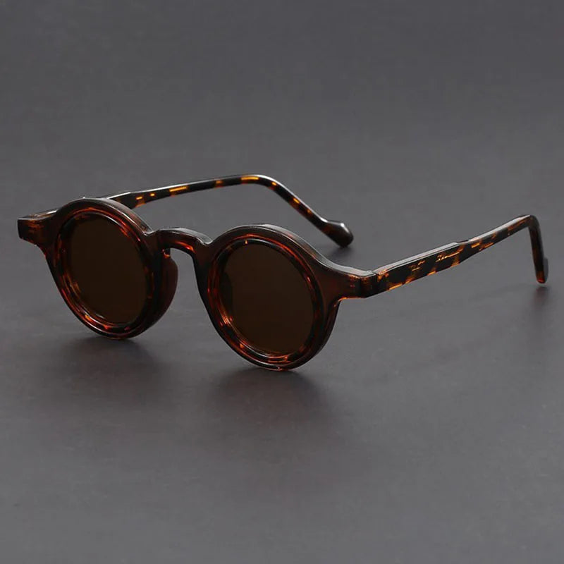 Model wearing Velari round frame sunglasses, demonstrating a chic and modern unisex look.