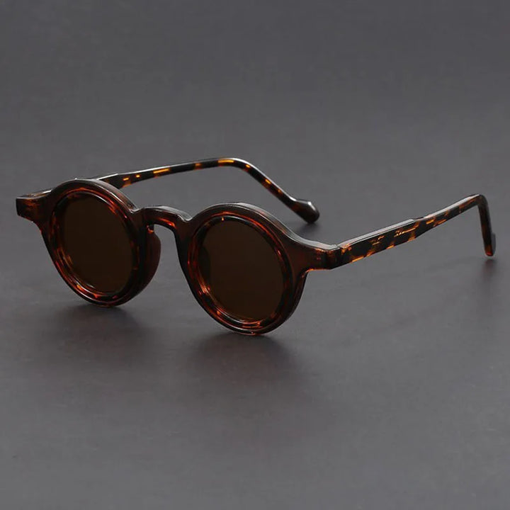 Model wearing Velari round frame sunglasses, demonstrating a chic and modern unisex look.