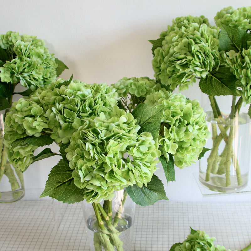 Close-up of a realistic artificial hydrangea bouquet, showcasing detailed petals and vibrant colors.