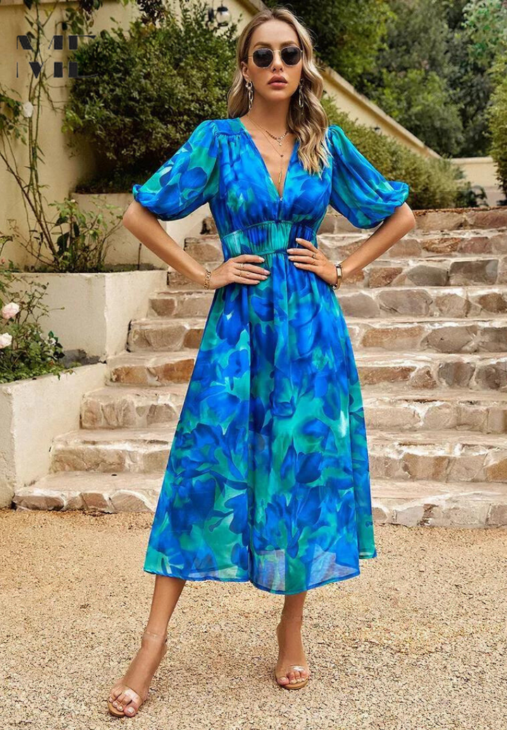 Stunning women's floral A-line midi dress with short sleeves, showcasing its elegant and flowy design.